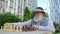 Close up thoughtful elderly retired man plays chess