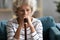 Close up thoughtful older woman with cane sitting alone