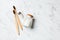 Close up of three bamboo toothbrushes and tooth powder