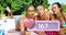 Close up of three Caucasian women laying on the beach tacking selfies