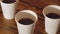 Close up of three cups of delicious coffee on the wooden table