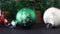 Close up of three cute Christmas ornaments. Green, white and red shiny Christmas ornaments on the table