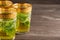 Close-up of three decorated mint tea glasses, selective focus, on wooden table, horizonta