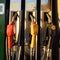 Close-up of three fuel nozzles for gasoline, refueling. Sunset light. Car ride. Travels