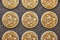 Close up of three golden dragon coins on black tile background