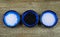 Close up of three isolated blue bowls with different kind of salt on wood table white flakes and grains, black Hawaii salt