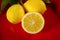 Close up of three lemons on a red plate