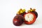 Close-up of three mangosteens in the white background