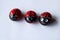 Close up of three painted stones as cute ladybugs