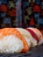 close-up of three pieces of sushi, dark background