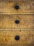 Close up of three rustic wooden drawers of an antique dresser