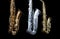 Close up of three saxophones standing