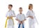 Close-up three sportive kids, little boys, taekwondo or karate athletes in doboks posing isolated on white background