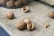 Close-up three walnuts. unpeeled and peeled walnuts in shells on a black table and in a glass jar.