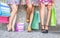 Close up of three women with shopping bags, floor view with high heels and shopping bags