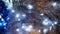 Close-up of tinsel with garland. Concept. Blue garland glows in silvery glittering tinsel. Christmas decorations