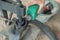 Close up of tire repairman`s hand when pouring fuel on a traditional press