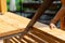 Close up to Asian female hand, she is sawing wooden table in outdoor field