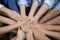 Close up to Asian people hold hand together in the middle of their group, friend with stack of hand showing the love and community