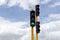 Close up to a bicycle traffic light, lighting green in a crossroad near to a traffic light lightinig red