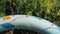 A close up to a blue waterpark shower fountain play structure at an amusement water park