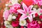 Close up to colorful plastic pink lilly flowers with roses and l