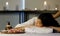 Close-up to focus massage equipment, wooden pump oil massage, wooden bowl, and flowers on wooden plates. And asian woman sleep