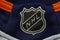 A close up to a NHL logo on a Blue hockey jersey