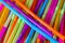 Close up to plenty colorful straws background