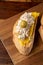 Close-up of toast with turkey breast pate with cheese, mango and olives, on wooden table and table