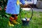 Close-up of of toddler girl with colorful stockings and shoes and basket with colored eggs. Child having fun with