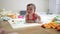 Close-up of a toddler surrounded by toys on the floor. Kindergarten family childhood concept. Close-up of a baby lying