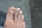 close up toes of asian adults,  at grey background