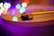 Close up of tonearm of isolated vintage retro record player with white vinyl lp. Shiny colorful bokeh background