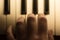 Close-up toned atmospheric photo of fingers playing piano. keys. Concept: Music creating, composing, lyrics