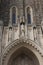 Close up of the top of the arched entryway and four statues above of the Duke University Chapel in Durham, North Carolina