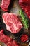 Close up top blade steak cutwith set of different alternative types of raw beef steaks on a rustic metall background top view