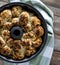 A close up top down view of a bundt pan filled with pull apart buns fresh out of the oven. Also known as monkey bread.