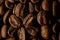 close-up top view of beautiful composition of aromatic dark roasted coffee beans.