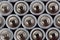 Close up top view on blurred rows of AA batteries energy abstract background of batteries.