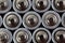 Close up top view on blurred rows of AA batteries energy abstract background of batteries.
