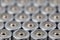 Close up top view on blurred rows of AA batteries energy abstract background of batteries.