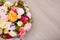 Close up top view of bunch of summer flowers and copy space over wooden background