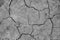 Close-up top view of a cracked part of the earth from a mud volcano, background, out of focus, blank for designers, selective