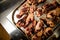 Close-up of top view of metal tray with grilled chicken legs