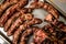 Close-up of top view of metal tray with grilled sausages