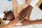 Close-up top view: multinational employees put their hands in a pile, showing support and unity, together towards a