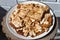 Close-up and top view of oblong pieces of home-made crumble cake with strawberry jam covered with meringue served on wooden table