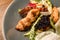 close-up top view of a piece of fried chicken and bacon in salad