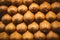 Close up, top view. Ripe kiwi are neatly laid out in rows on the counter at a Spanish bazaar